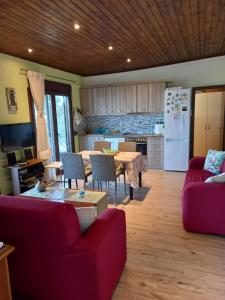 a living room with a table and a kitchen at Glastri Ammouliani in Ammouliani