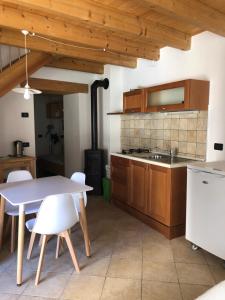 a kitchen with wooden cabinets and a table and chairs at Maso Arlanch 8 in Vallarsa