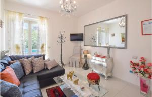 a living room with a blue couch and a mirror at Lovely Home In Tortora Praia A Mare With House Sea View in Praia a Mare