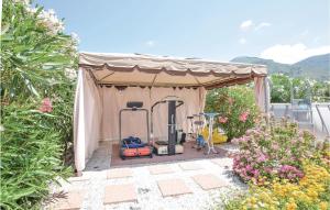 a gazebo with gardening equipment in a garden at Beautiful Home In Tortora Praia A Mare in Praia a Mare