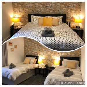 sypialnia z 2 łóżkami i ręcznikami w obiekcie Stylish modern 3-bed house nr Manchester city ctr w mieście Whitefield