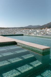 a swimming pool with a view of a city at Hotel Estepona Plaza in Estepona +94 photos