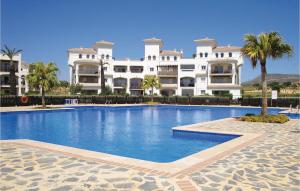 a swimming pool in front of a large building at Hacienda Riquelme in Sucina