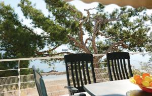 two chairs and a table with a bowl of fruit on a balcony at Nice Apartment In Port De Pollença in Port de Pollensa
