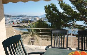 a table and chairs on a balcony with a view of a harbor at Nice Apartment In Port De Pollença in Port de Pollensa