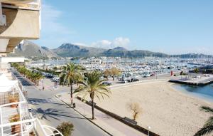 a view of a marina with palm trees and a beach at Beautiful Apartment In Port De Pollena With Kitchen in Port de Pollensa