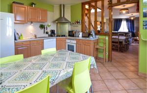 cocina con mesa con sillas verdes y cocina con comedor en Stunning Home In Criquetot-L'esneval, en Criquetot-lʼEsneval