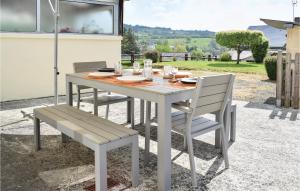 a table and two chairs and a table and a table and chairs at 3 Bedroom Gorgeous Home In Pont Douilly in Pont-d'Ouilly