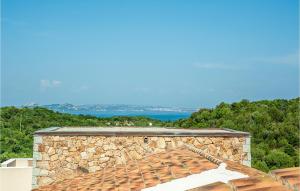 a roof of a stone building with the ocean in the background at Trilo 6 in Baja Sardinia