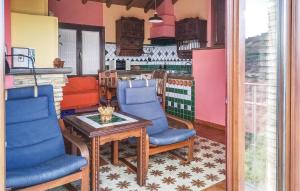 a room with a table and chairs and a kitchen at Cozy Home In Benalaura With House A Mountain View in Benalauría