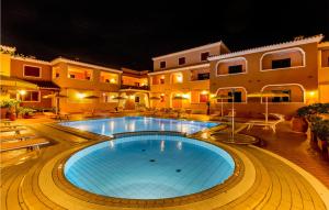 a large swimming pool in front of a building at Beautiful Apartment In Orosei With Wifi in Orosei