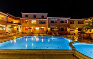 a large swimming pool in front of a building at Beautiful Apartment In Orosei With Wifi in Orosei +6 photos