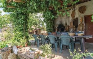 a patio with a table and chairs in a garden at Awesome Apartment In Castellabate Sa in Castellabate