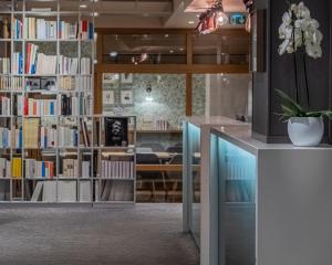 a library with book shelves filled with books at Hotel Litteraire Le Swann, BW Premier Collection in Paris
