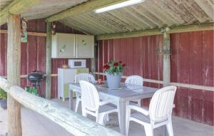 a table and chairs on a patio with a kitchen at Cozy stacaravan In Franquevaux With Kitchen in Franquevaux