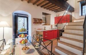a kitchen with a glass table and red cabinets at Alabarda in Vasciano Nuovo