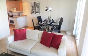 a living room with a white couch and a table at Nice Home In Ciudad Quesada With Kitchenette in Ciudad Quesada