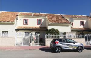 a silver car parked in front of a house at 2 Bedroom Cozy Home In Ciudad Quesada in Ciudad Quesada