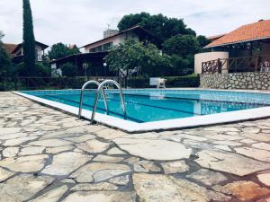 een zwembad met een stenen loopbrug eromheen bij Horizonte da serra 1 in Gravatá +32 foto's