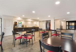 a restaurant with tables and chairs and a kitchen at Red Roof Inn Chester in Chester