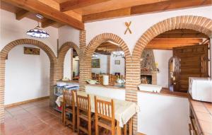 a kitchen with arched ceilings and a table and chairs at Stunning Home In Sayalonga With 13 Bedrooms, Wifi And Outdoor Swimming Pool in Sayalonga