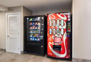 a soda machine is next to a soda vending machine at Red Roof Inn Chester in Chester