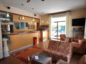 a living room with couches and a bar at Hotel Marina in Bardolino