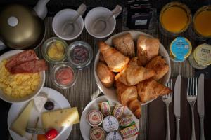 a table topped with plates of bread and other foods at Hotel Litteraire Le Swann, BW Premier Collection in Paris