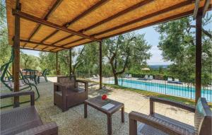 a covered patio with a table and chairs and a pool at Leccino in Lamporecchio