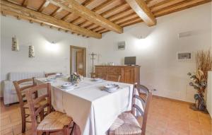 a dining room with a white table and chairs at Leccino in Lamporecchio +7 photos