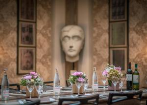 a table with wine bottles and flowers on it at Hotel Litteraire Le Swann, BW Premier Collection in Paris