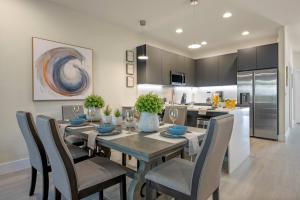 a kitchen and dining room with a table and chairs at Hidden Forest 3 Bedroom Vacation Townhome with pool -2020 in Clermont