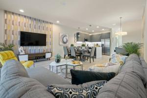 a living room with a couch and a dining room at Hidden Forest 3 Bedroom Vacation Townhome with pool -2020 in Clermont