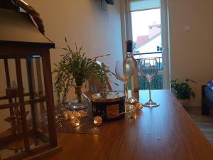 a wooden table with wine glasses and lights on it at Restauracja Hotel 4u in Kańczuga
