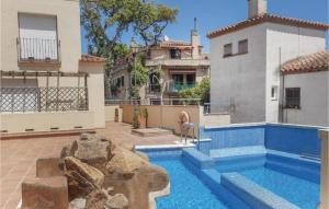 a villa with a swimming pool and a house at Beautiful Home In Tossa De Mar With 4 Bedrooms, Wifi And Swimming Pool in Tossa de Mar