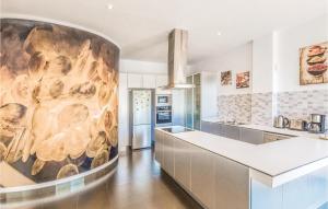 a kitchen with a large painting on the wall at Nice Home In Santa Susanna With Kitchen in Santa Susanna