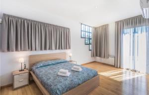 a bedroom with a bed with two towels on it at Nice Home In Santa Susanna With Kitchen in Santa Susanna