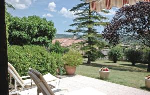 a patio with chairs and a view of a garden at Mas Mirasol in Gargas