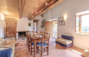 a living room with a table and chairs and a fireplace at Poggio Vecchio in Molino Moscano