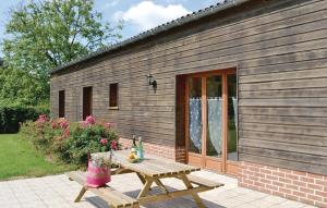 a wooden picnic table in front of a building at Awesome Home In Gueschart With 2 Bedrooms And Wifi in Gueschart