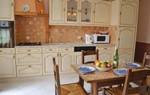 a kitchen with a table with a bowl of fruit on it at Awesome Home In Gueschart With 2 Bedrooms And Wifi in Gueschart