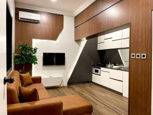 a living room with a couch and a kitchen at Whytescape Serviced Apartments in Abuja