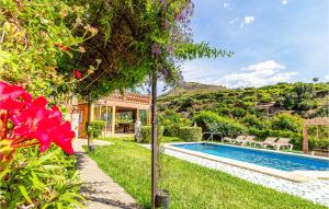 a house with a swimming pool in a yard at 3 Bedroom Awesome Home In Nerja in Nerja