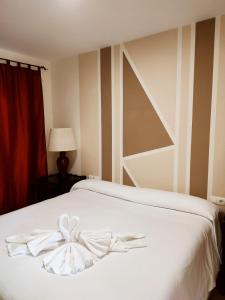 Postel nebo postele na pokoji v ubytování Hostal Alhaja Playa