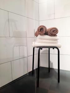 a stack of towels on a stool in a bathroom at Casa de Piedras by SIERRA VIVA desing in Cortelazor +18 photos