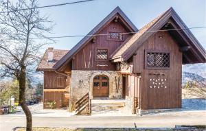 a large wooden house with a large door at Picchio in Comeglians