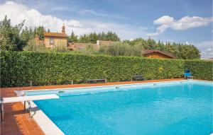 a large swimming pool in front of a hedge at Il Nido in Panicarola