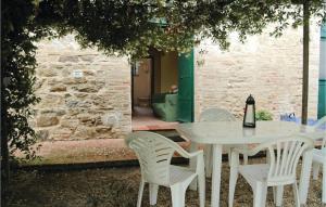 a white table and chairs with a bottle of wine on it at Vigna D in Bevagna