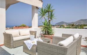 a patio with wicker chairs and a table at Splendido Appartamento in Santa Maria di Castellabate