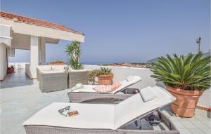 a patio with chairs and a table on a roof at Splendido Appartamento in Santa Maria di Castellabate +14 photos